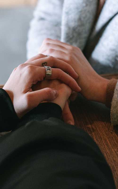 Hands holding in a supportive moment