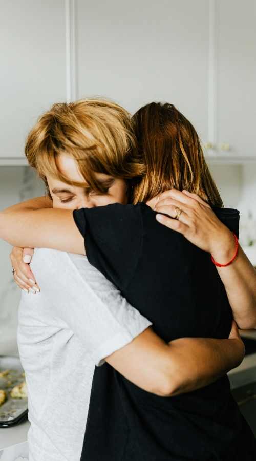 Couple hugging during a supportive moment