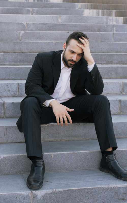 Person sitting on steps during a difficult moment